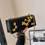 PU leather shoulder bag features decorative gold-toned butterfly embellishments and a matching gold chain strap - Image 2